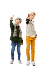 Cute little boys showing victory gesture on white background