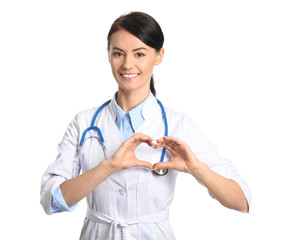 Female cardiologist making heart with her hands on white background