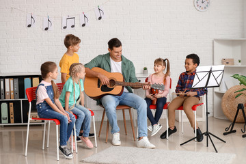 Teacher giving music lessons at school