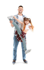 Father and his little daughter dancing against white background