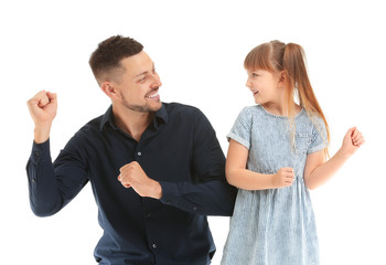 Father and his little daughter dancing against white background