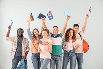 Young students of language school on color background