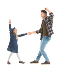 Fototapeta premium Man and his little daughter dancing against white background