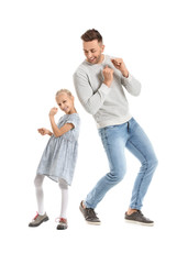 Man and his little daughter dancing against white background