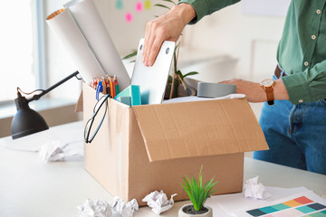Fired man packing things in office