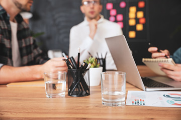 Glasses of water on table during meeting in office