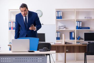 Young male businessman working in the office