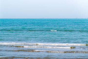 Small waves on an empty beach