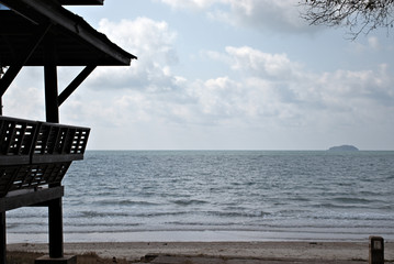 View of the ocean on a cloudy day with Thai sun shelter to the left