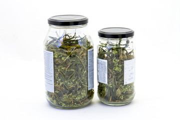 Two bottles of homegrown marijuana isolated on a clear background image with copy space in horizontal format