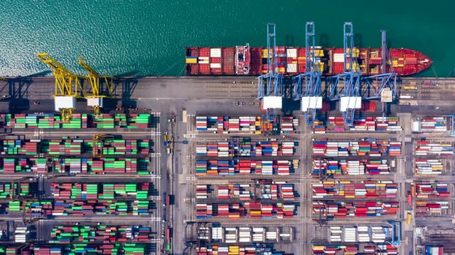 4K, Aerial footage Container ship carrying container box in import export with quay crane, Global business cargo freight shipping commercial trade logistic and oversea worldwide by container vessel.