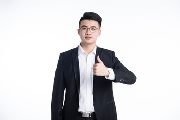 A young Asian man is using his mobile phone and laptop