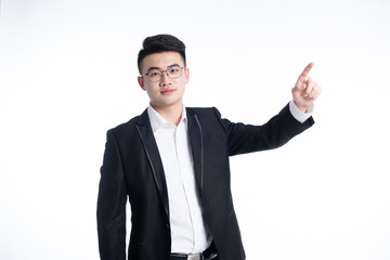 A young Asian man is using his mobile phone and laptop