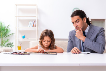 Child psychologist attending small girl