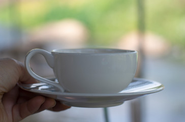 close up a white coffee cup on blurred background