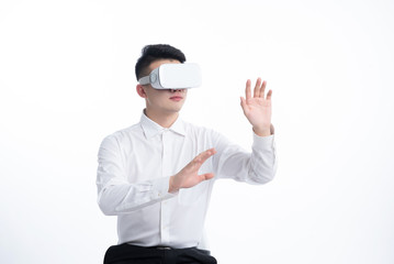 A young Asian man is using his mobile phone and laptop