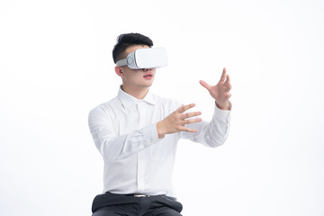 A young Asian man is using his mobile phone and laptop