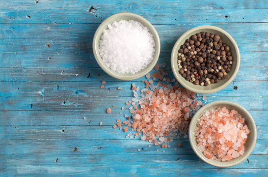 Himalayan salt on a blue wooden background.