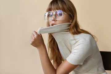 Fotobehang Stylish beautiful fashion girl wear trendy sunglasses looking at camera, retro vogue sexy attractive young model woman blond hair in eyewear posing on beige studio background, portrait © insta_photos