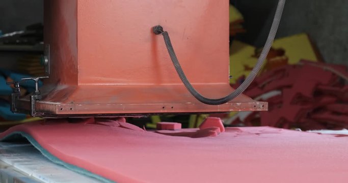 Paralon sponge factory, press conveyor, cutting red synthetic material into hexagonal dishwashing sponges, production process in factory, China, Chinese production, work continues despite quarantine