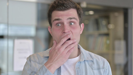 Naklejka premium The Portrait of Astonished Young Male Designer in Shock