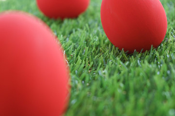 red easter egg on lawn green grass artificial, image of morning springtime concept
