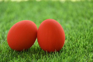 red easter egg on lawn green grass artificial, image of morning springtime concept