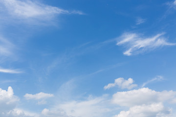 fluffy white cloud moving above clear blue sky