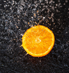 Fototapeta na wymiar orange in a spray of juice