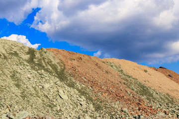 Fototapeta na wymiar View of slag heaps of iron ore quarry. Mining industry
