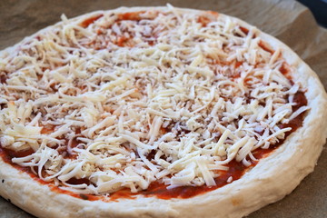 Pizza base with grated cheese