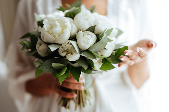 Close-up image of a beautiful and stylish wedding bouquet of white and pink peonies. Summer floral composition.