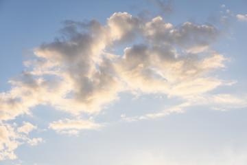 Blue sky with floating white clouds. The background.