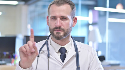 The Portrait of Young Doctor saying No with Finger Sign