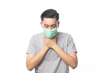 Young Asian Man in hygienic mask suffering sore throat, 2019-nCoV or coronavirus. Airborne respiratory illness such as pm 2.5 fighting and flu. Studio shot isolated on white background.