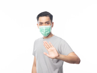 Young Asian Man wearing hygienic mask gesturing stop to prevent infection, 2019-nCoV or coronavirus. Airborne respiratory illness such as pm 2.5 fighting and flu.isolated on white background.