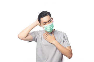 Young Asian Man in hygienic mask suffering sore throat and having flu, 2019-nCoV or coronavirus. Airborne respiratory illness such as pm 2.5 fighting. Studio shot isolated on white background.