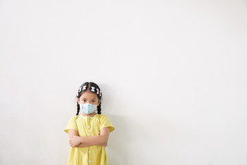 Asian child or kid girl wear N95 paper face mask for close mouth and sick on nose with cold cough...