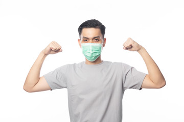 Young Asian Man in hygienic mask showing strength to prevent infection, 2019-nCoV or coronavirus. Airborne respiratory illness such as pm 2.5 fighting and flu.isolated on white background.