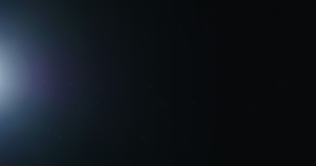 natural dust particles float in air on black background