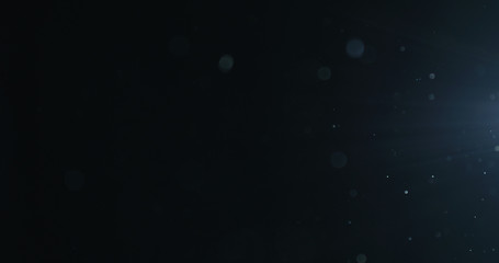 natural dust particles float in air on black background