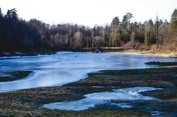 Frozen lake in the Park. Landscape with river and trees