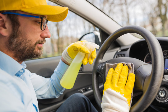 Car Wash Worker Disinfecting Vehicle Interior.