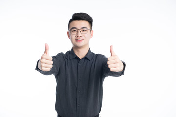 A young Asian business man stood behind his desk