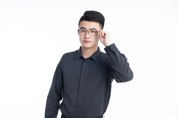 A young Asian business man stood behind his desk