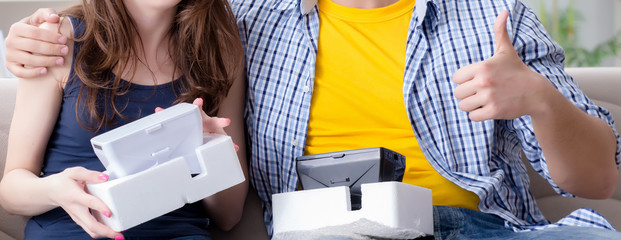 Young family playing games with virtual reality glasses