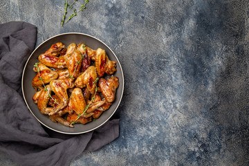 Roasted chicken wings in sweet sauce. Top view copy space