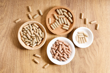 herbal pills on wooden background