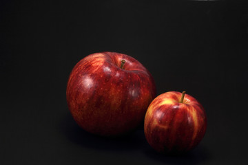 Fototapeta na wymiar Two apples on black background
