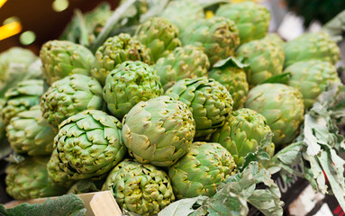 Fresh artichokes on market counter